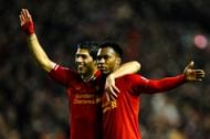 Daniel Sturridge (R) of Liverpool is congratulated by teammate Luis Suarez (L) after scoring his team's third goal against Everton at Anfield